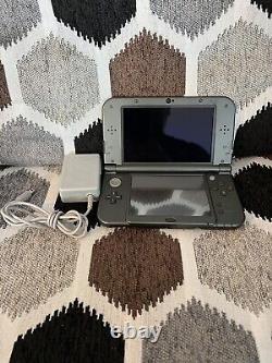 Nintendo 3DS XL Noir d'occasion en bon état avec chargeur, testé et fonctionnel